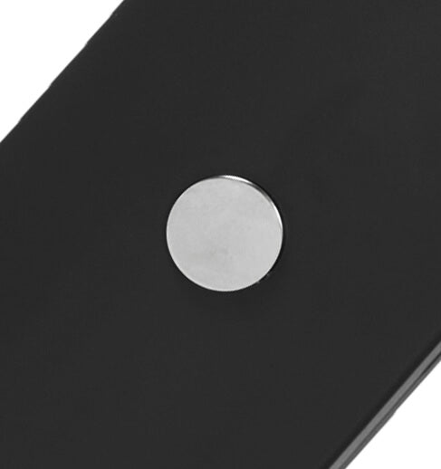 A close-up of a black rectangular work light featuring a circular silver metallic magnet.