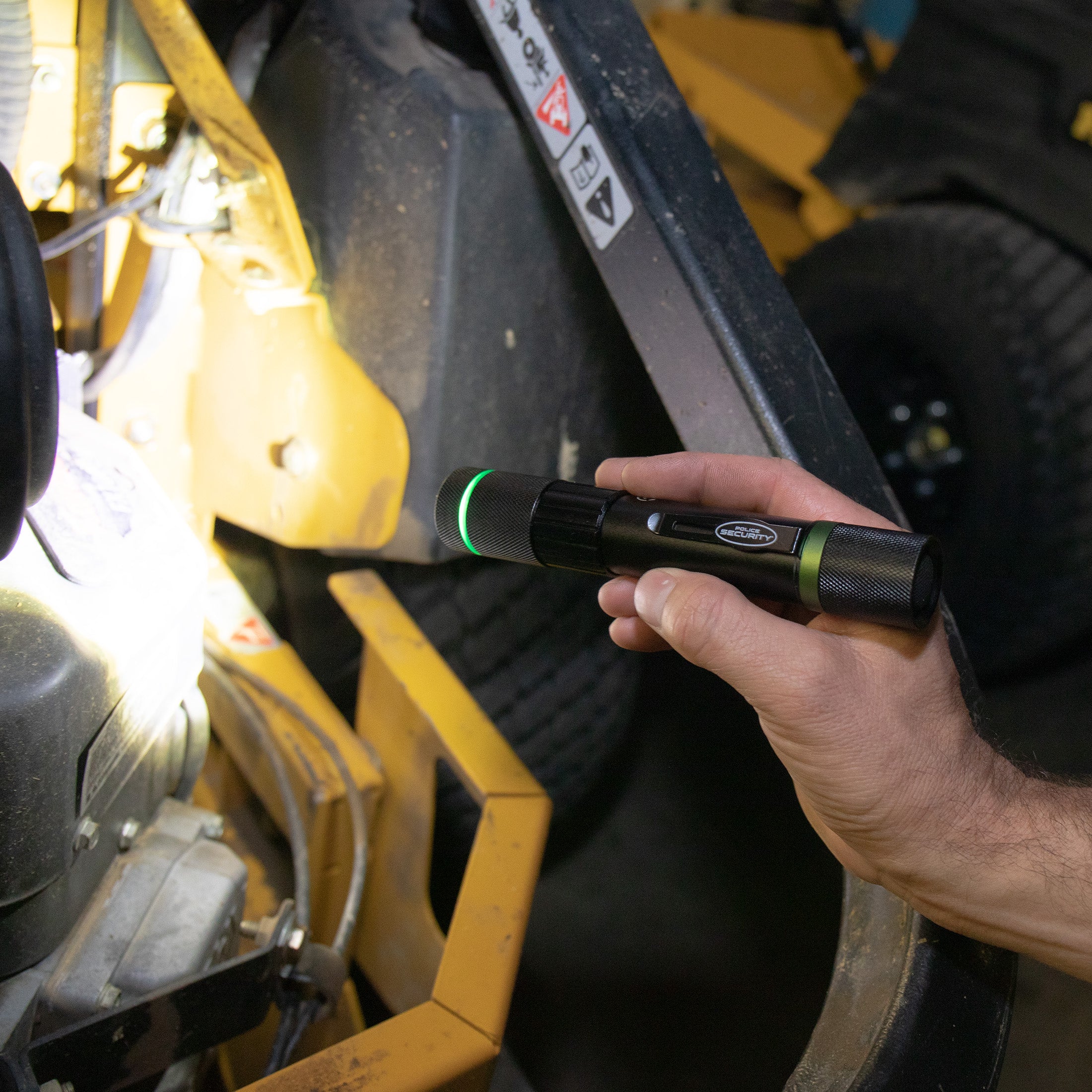 an image of a hand lighting machine parts with the DOVER 1000 LUMEN RECHARGEABLE FLASHLIGHT