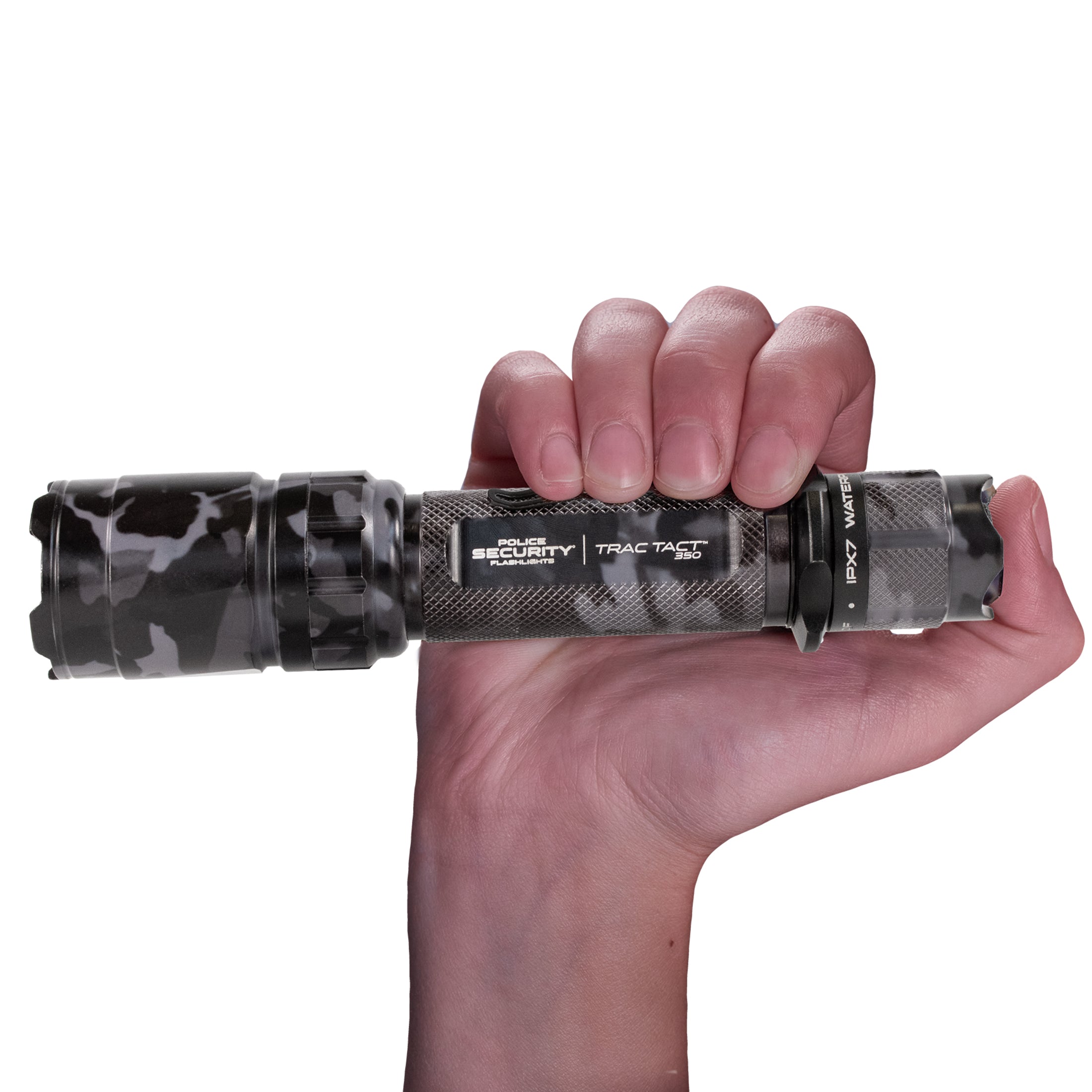 The camo version of the Trac Tact UV flashlight held in a hand