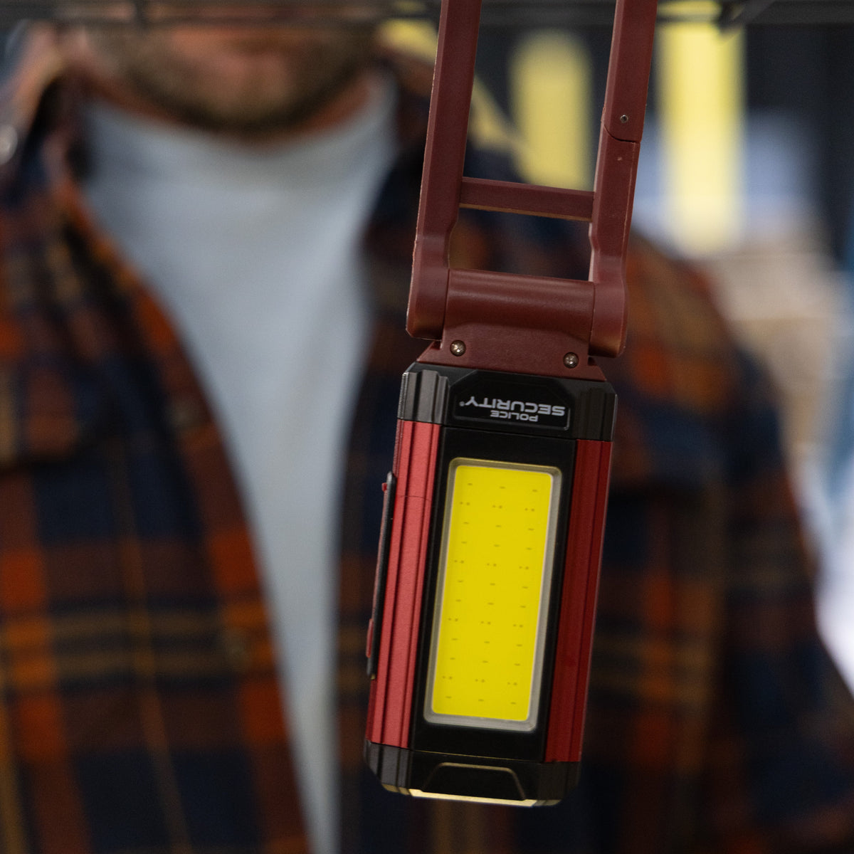 The Kickstand R Mini Police Security Work light hanging from a wire rack