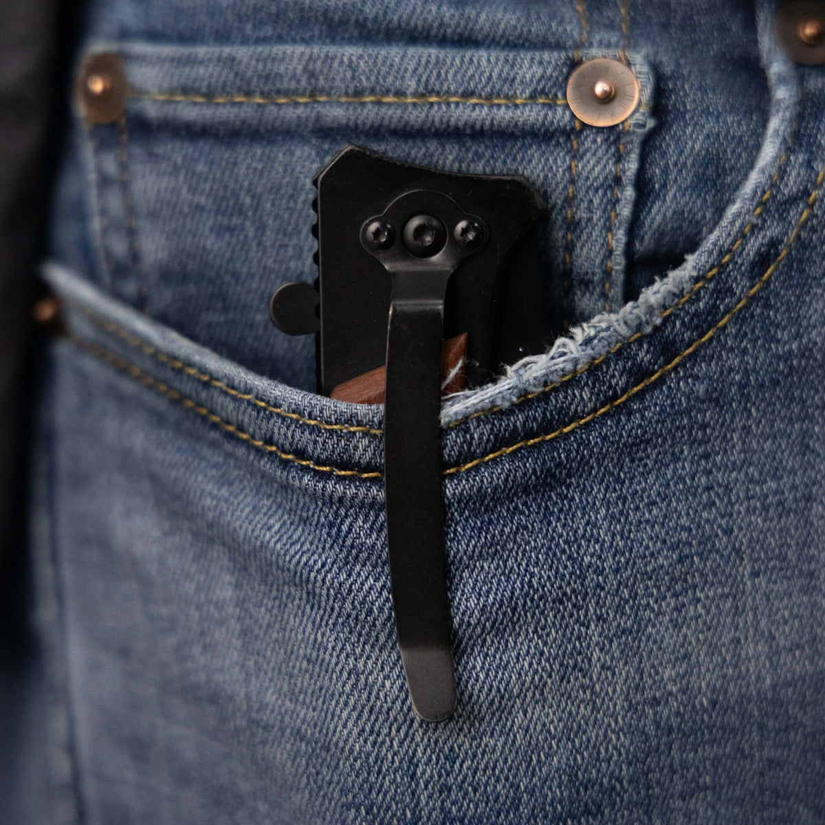 The Ridgeline pocket knife clipped to a blue jeans pocket