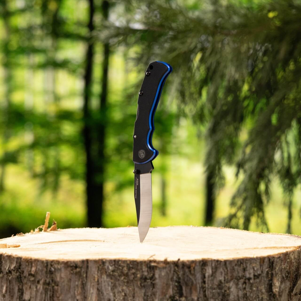 Rover pocket knife stabbed into a tree stump in the woods
