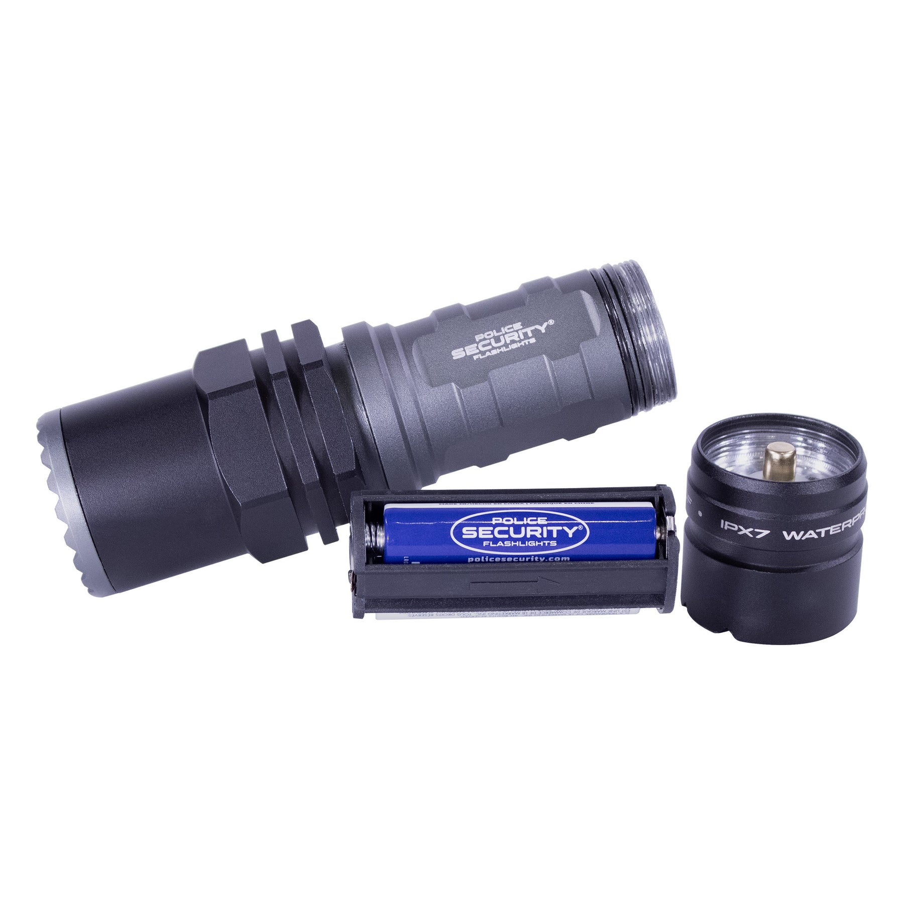 The battery carrier of the Long Throw AAA flashlight lying next to the flashlight