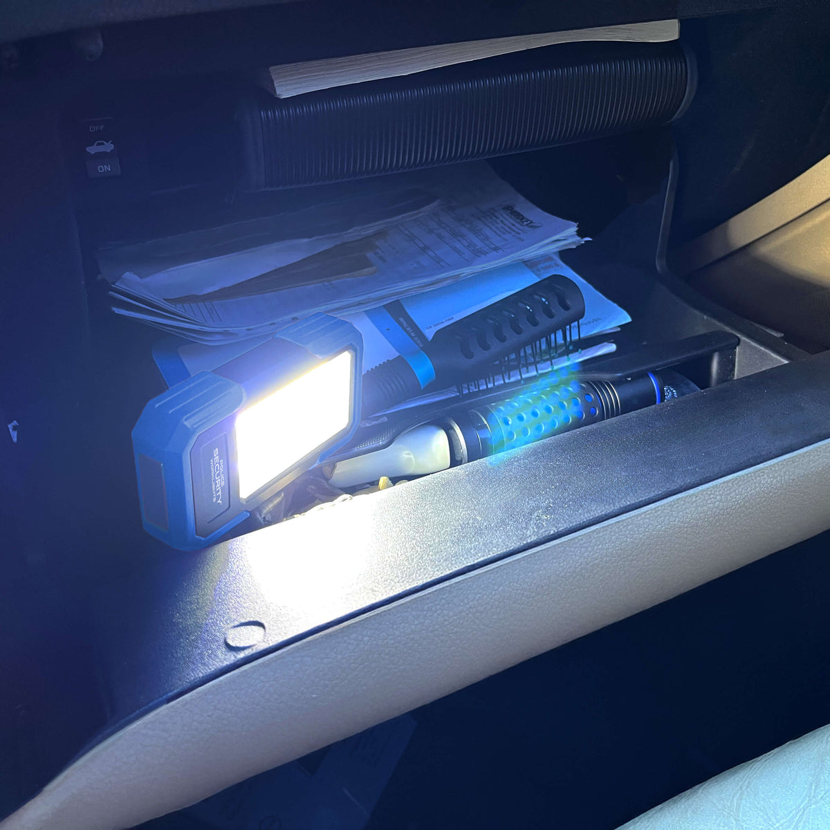 The Widescope Mini work light used inside of a car glove box