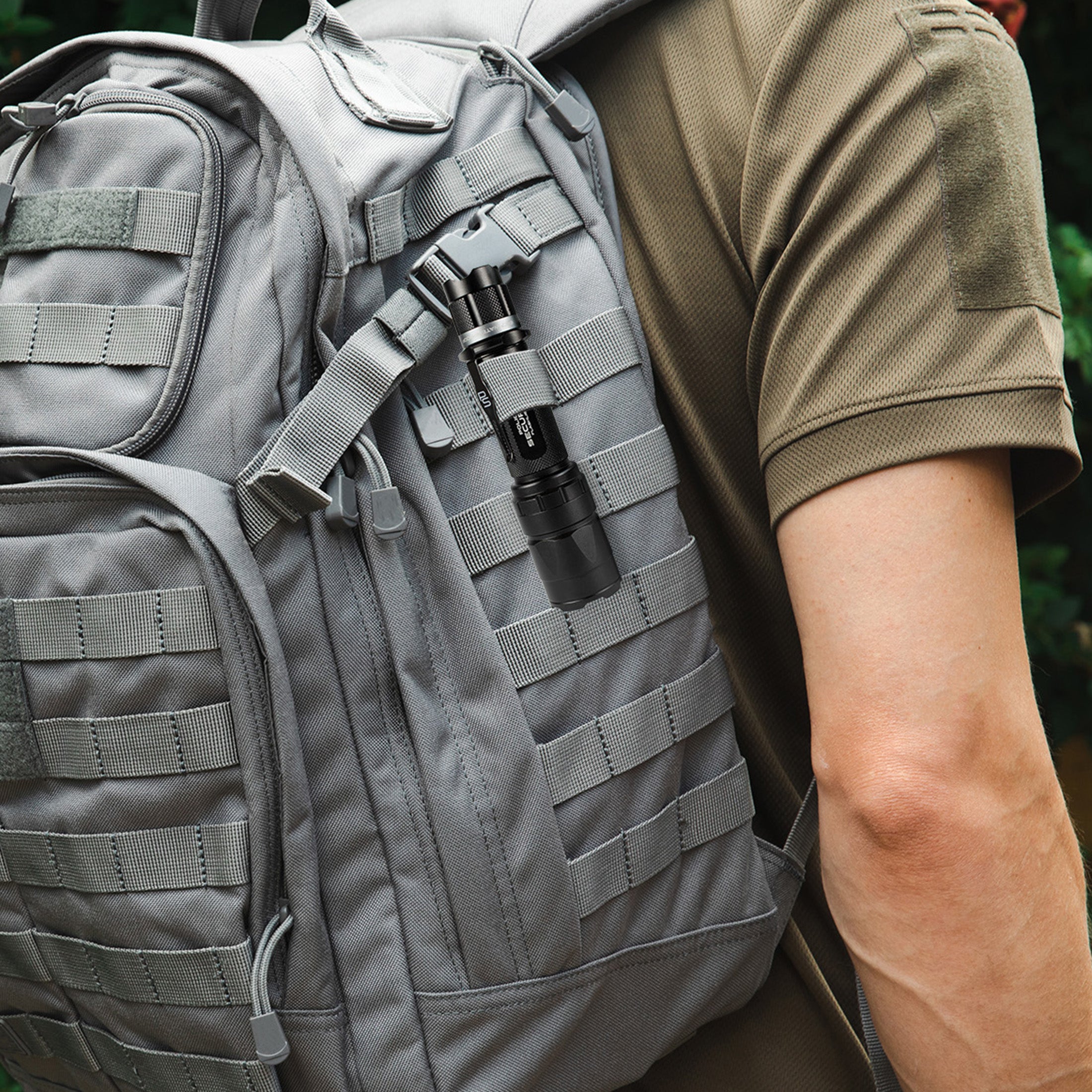 The Police Security Trac Tact RX tucked into a backpack carry strap