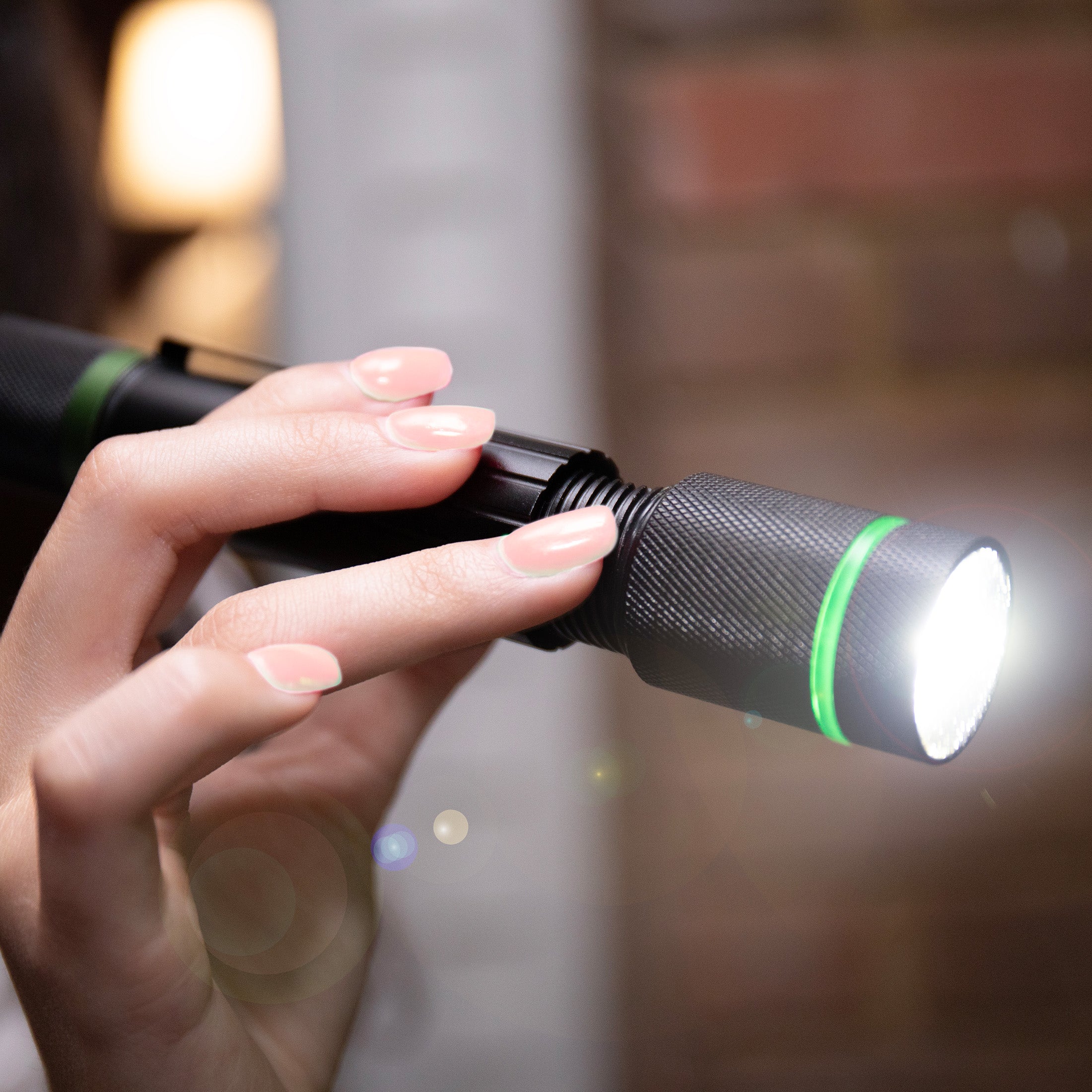an image of a female hand holding the DOVER 1000 LUMEN RECHARGEABLE FLASHLIGHT