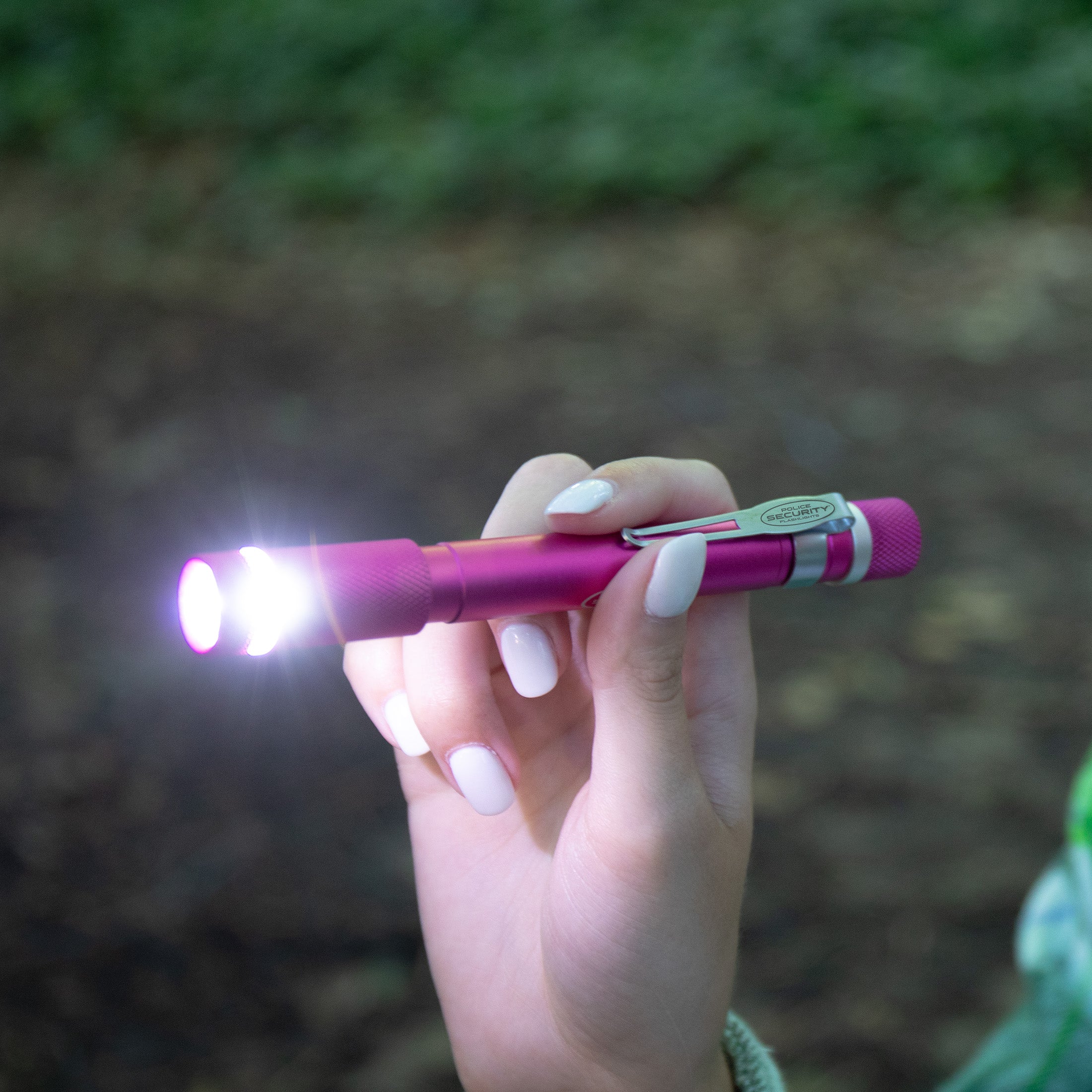 an image of a female hand holding the Pink AURA PENLIGHT