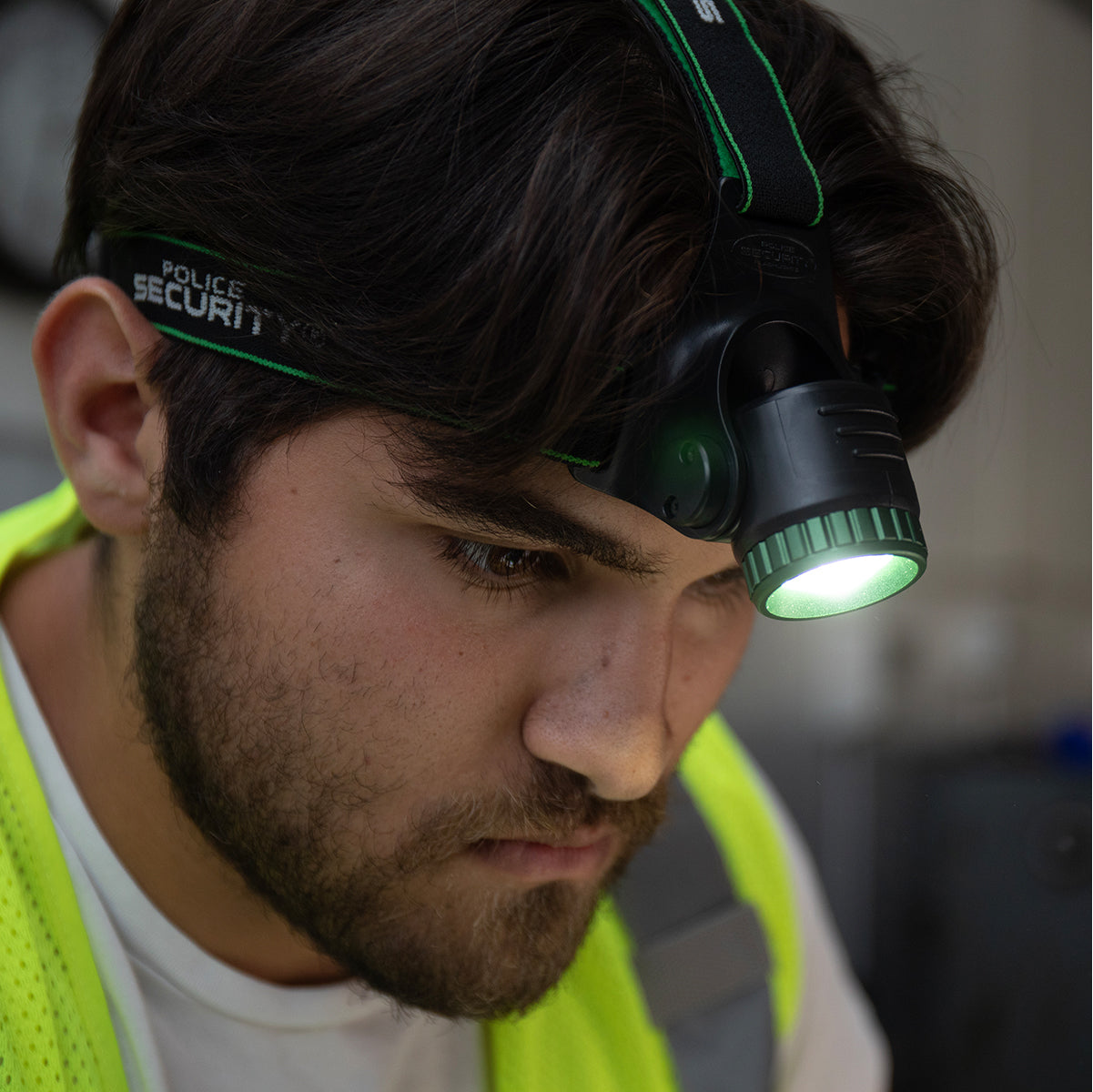an image of a man with the BLACKOUT-R 1000 LUMEN RECHARGEABLE HEADLAMP on his head