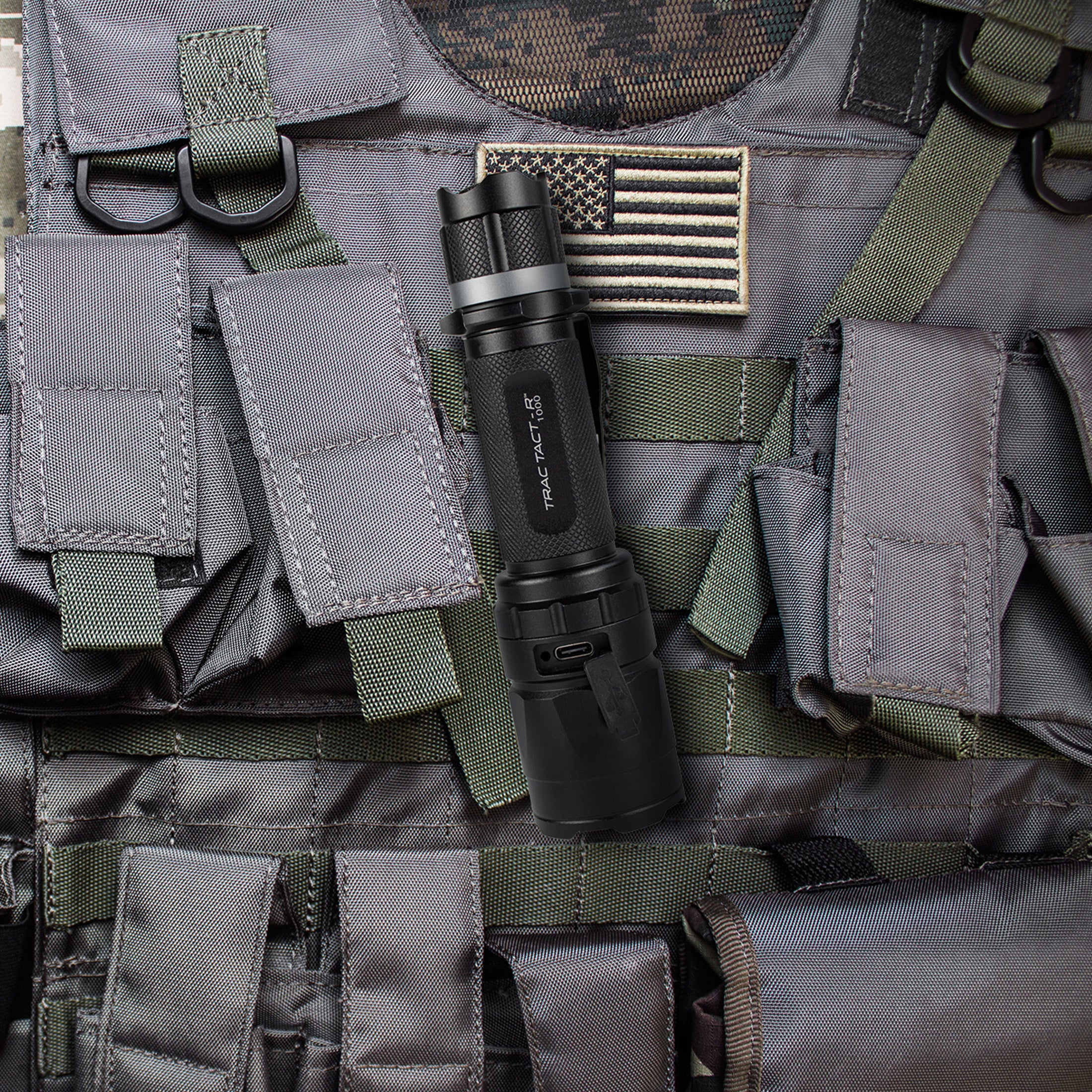 The Trac Tact-R flashlight lying on a tactical vest