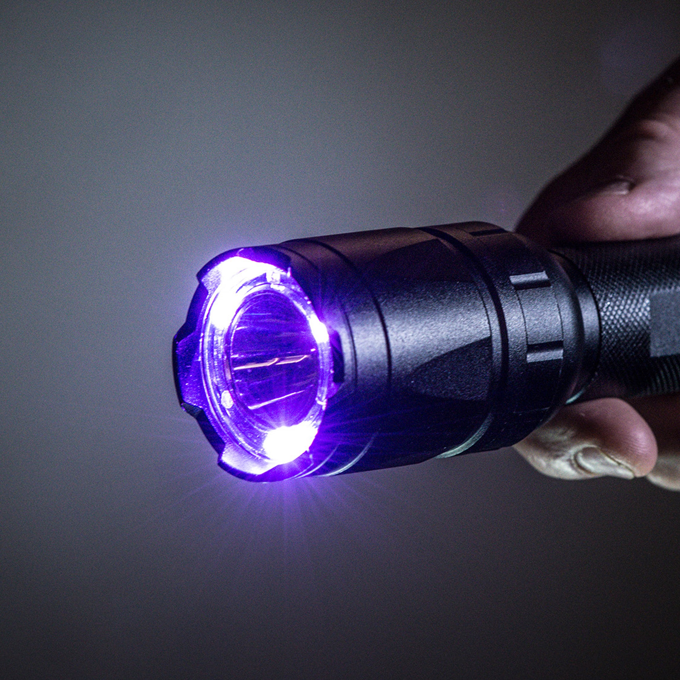 an image of the TRAC TACT 350 LUMEN WITH UV FLASHLIGHT with turned on UV light