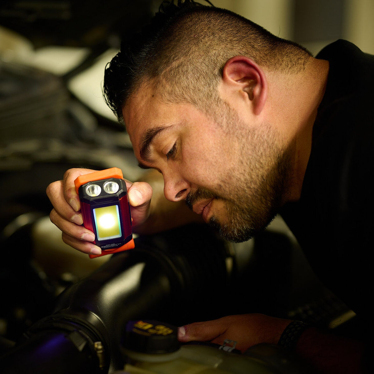 The Kickstand-R Mini COB light feature used to illuminate a wide area of a car's under hood