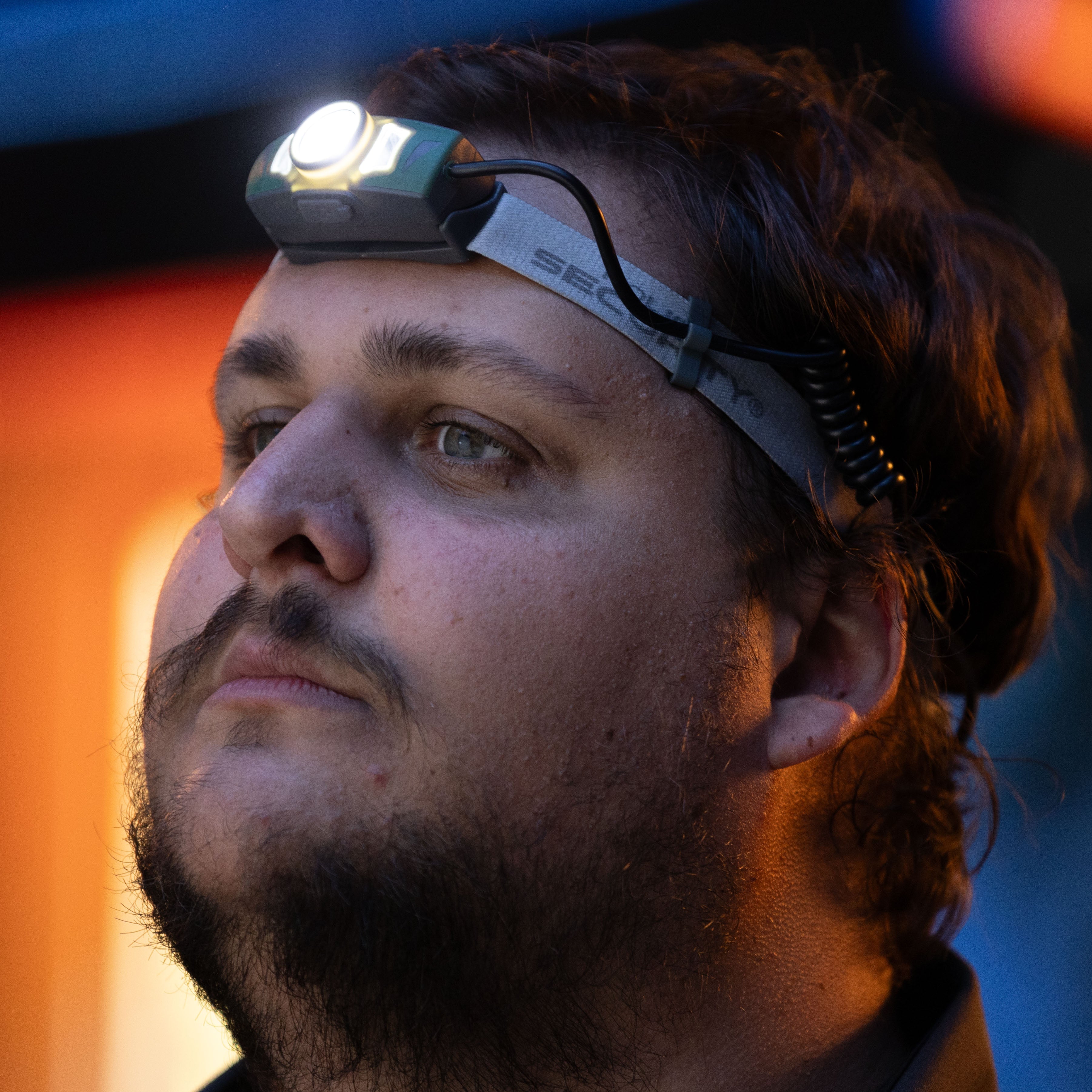The Police Security Twin Power headlamp worn on a man's head