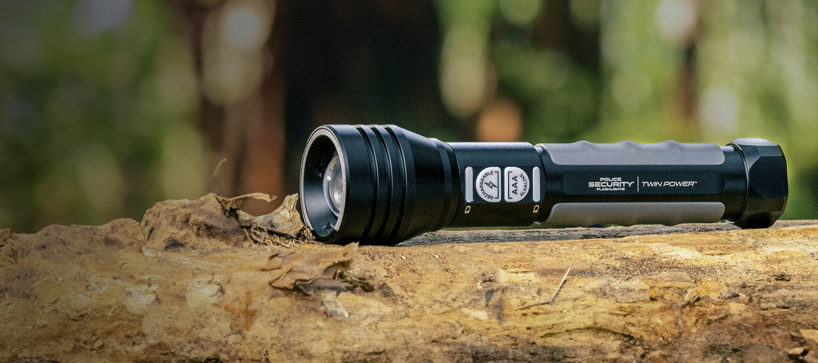 a large close up hero image of a Twin Power flashlight in nature 