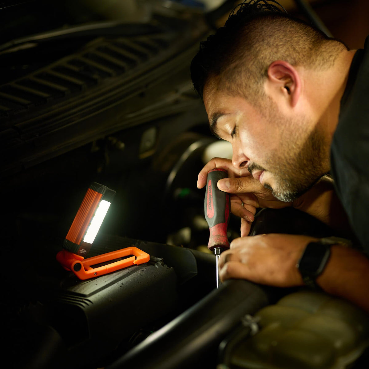 The Kickstand-R Mini worklight used to illuminate an automotive worker
