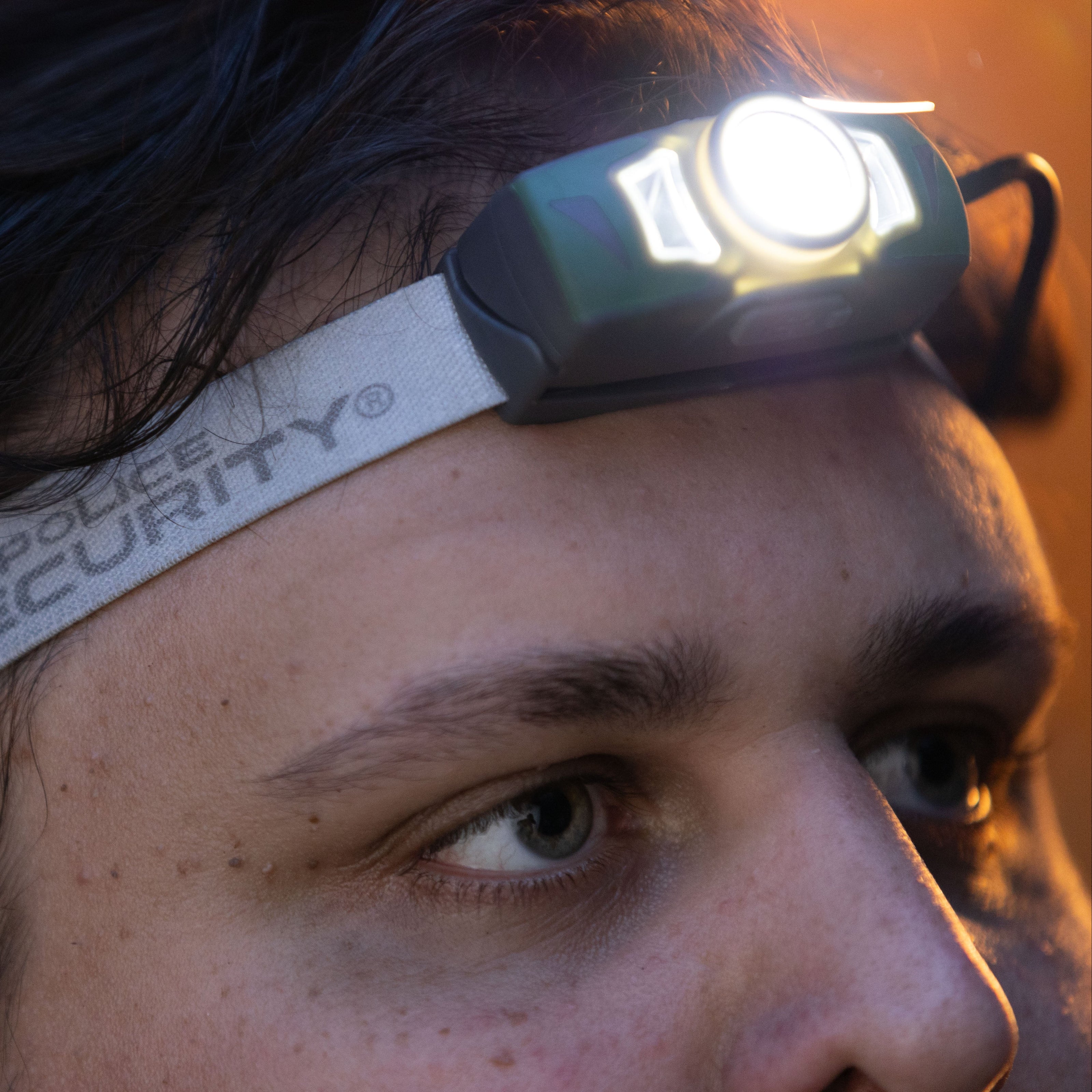 The Twin Power headlamp worn on a man's head